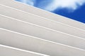 White wooden louver window fragment with sky visible outside Royalty Free Stock Photo