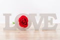 White wooden love letters with red rose