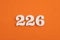 Number 226 - On orange foam rubber background
