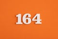 Number 164 - On orange foam rubber background