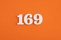 White wooden number 169 on eva rubber orange background