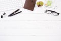 White wooden office desk table with red notebook, black pen, coffee cup and other office supplies. Top view with copy space, flat Royalty Free Stock Photo