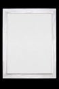 White wooden painted frame with white blank canvas isolated on black background Royalty Free Stock Photo