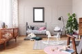White wooden rocking horse on patterned carpet in elegant mid century baby room interior, real photo with mockup poster on the Royalty Free Stock Photo