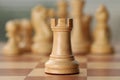 White wooden rook on chess board, closeup Royalty Free Stock Photo