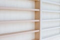 White Wooden Shelf on a Wall in Light Room Royalty Free Stock Photo