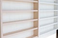White Wooden Shelf on a Wall in Light Room Royalty Free Stock Photo