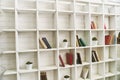 White wooden shelves with old books. Wooden bookcase. Royalty Free Stock Photo