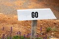 white wooden signpost with the word go