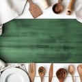 White wooden table covered with green tablecloth and cooking utensils. View from top. Empty tablecloth for product montage Royalty Free Stock Photo