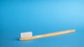 White wooden toothbrush. Blue background with copy space for text Royalty Free Stock Photo