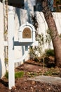 White wooden US mail letterbox with metal emboss eagle symbol on the front yard of a house. Editorial Royalty Free Stock Photo