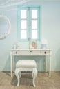 White wooden vanity table with window in background Royalty Free Stock Photo