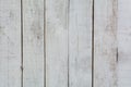 The texture of a worn white wooden wall. White boardwalk fence.