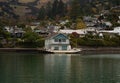 White wooden waterfront boat house built on stilts historic architecture, French Bay Akaroa Banks Peninsula New Zealand Royalty Free Stock Photo