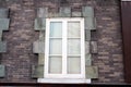 White wooden window on brick wall