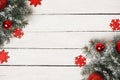 White wooden winter Christmas background with fir tree, red decorations and snow, copy space Royalty Free Stock Photo