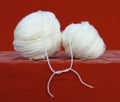 White Wool Balls Tied Up on Red Background Royalty Free Stock Photo