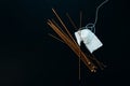 white wool knitting needles and a piece of knitting against a black background Royalty Free Stock Photo