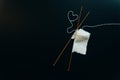 white wool knitting needles and a piece of knitting against a black background Royalty Free Stock Photo