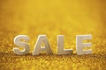 Word sale over golden glitter background