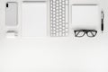 White work desk. Mobile phone, keyboard, pen, notebook and glasses. Royalty Free Stock Photo