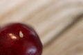 White worm in a cherry tree. A wormy cherry seen up close. A worm in a cherry fruit seen close up