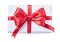 White wrapped gift box with red ribbon isolated on white Royalty Free Stock Photo