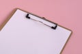 White writing paper on a pink background
