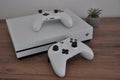 Xbox One S two joypads and console on desk