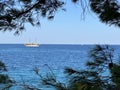 White yacht in the bay of the Adriatic Sea. Boat with a sail near the sea coast. Holidays on the open sea on a small boat. Croatia Royalty Free Stock Photo