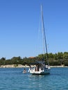 White yacht in the bay of the Adriatic Sea. Holidays on the open sea on a small boat. Boat with a sail near the sea coast Royalty Free Stock Photo