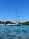 White yacht in the bay of the Adriatic Sea. Holidays on the open sea on a small boat. Boat with a sail near the sea coast Royalty Free Stock Photo