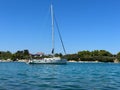 White yacht in the bay of the Adriatic Sea. Holidays on the open sea on a small boat. Boat with a sail near the sea coast Royalty Free Stock Photo