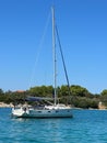 White yacht in the bay of the Adriatic Sea. Holidays on the open sea on a small boat. Boat with a sail near the sea coast Royalty Free Stock Photo