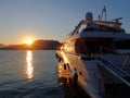 The white yacht in the blue dawn twilight sparkle& x27;s beautifully in the golden rays of the rising sun from behind the Royalty Free Stock Photo