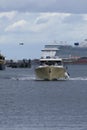 White yacht cruising near leaving port of ships Royalty Free Stock Photo