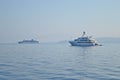 White yacht and a cruiser on the sea nearby Corfu