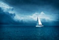 White Yacht Sailing in Stormy Sea. Dark Photo. Royalty Free Stock Photo