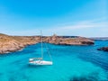 White yacht stands in azure transparent water sea, beach Blue Lagoon Comino Malta. Aerial view Royalty Free Stock Photo