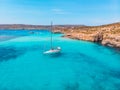 White yacht stands in azure transparent water sea, beach Blue Lagoon Comino Malta. Aerial view Royalty Free Stock Photo