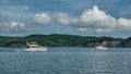 White yachts sail on the ocean. A foam trail behind the stern.