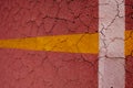 White and yellow bands on cracked maroon background.