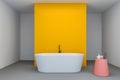 White and yellow bathroom interior, tub