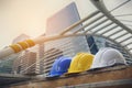 White, yellow and blue hard safety helmet hat for safety project of workman as engineer or worker, on concrete floor on city Royalty Free Stock Photo
