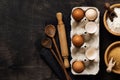 White and yellow chicken eggs and shells in an old cellulose vintage container with flour, sugar, wooden spoons and a rolling pin Royalty Free Stock Photo