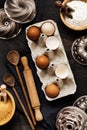 White and yellow chicken eggs and shells in an old cellulose vintage container with flour, sugar, wooden spoons and a rolling pin Royalty Free Stock Photo