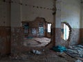 Abandoned house with concrete walls built from white bricks