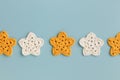 White and yellow crocheted stars row pattern on a blue background Royalty Free Stock Photo
