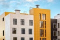 White and yellow modern ventilated facade with windows. Fragment of new typical commercial complex, educational or Royalty Free Stock Photo